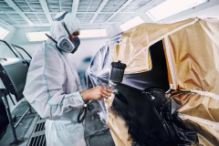 Painting the car in black color in the paint chamber on the service..